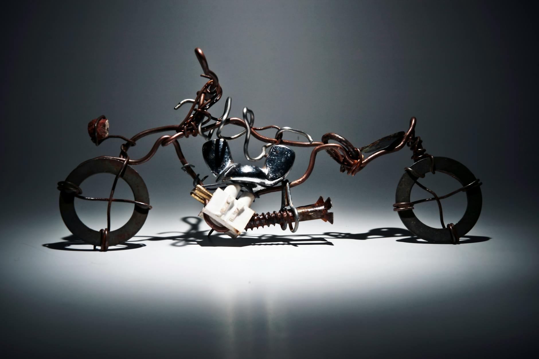 Creative recycled metal motorcycle sculpture made from wire and iron materials.